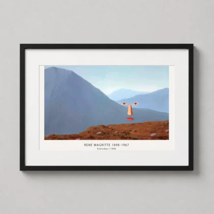 A framed Rene Magritte Everyday art print hanging in a modern living room featuring a floating face over mountain peaks.