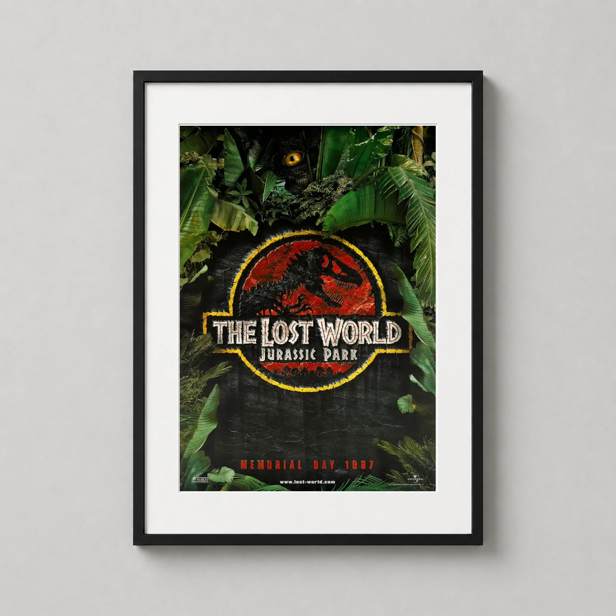 Room mockup of The Lost World Jurassic Park 1997 Movie Poster, displayed as framed wall art in a home theater setting as a portrait print with green and red tones.