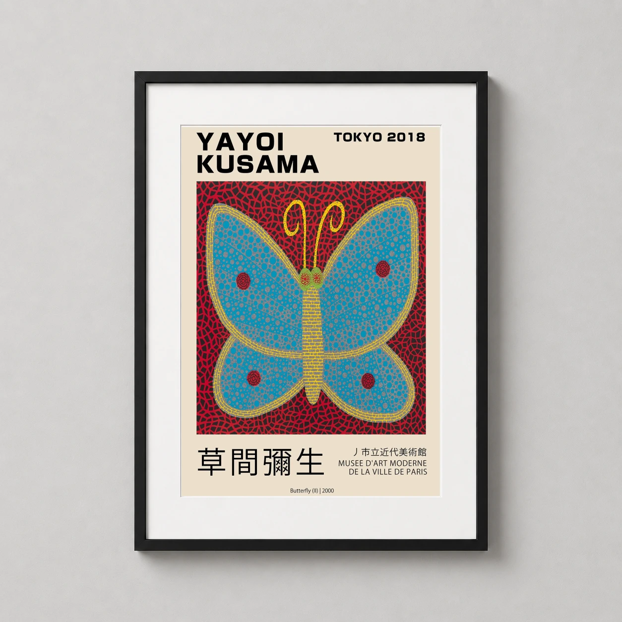 Room mockup of Yayoi Kusama Butterfly II 2000 Tokyo Exhibition Wall Art Print, displayed as framed wall art in a living room setting as a portrait print with blue, yellow, and red tones.