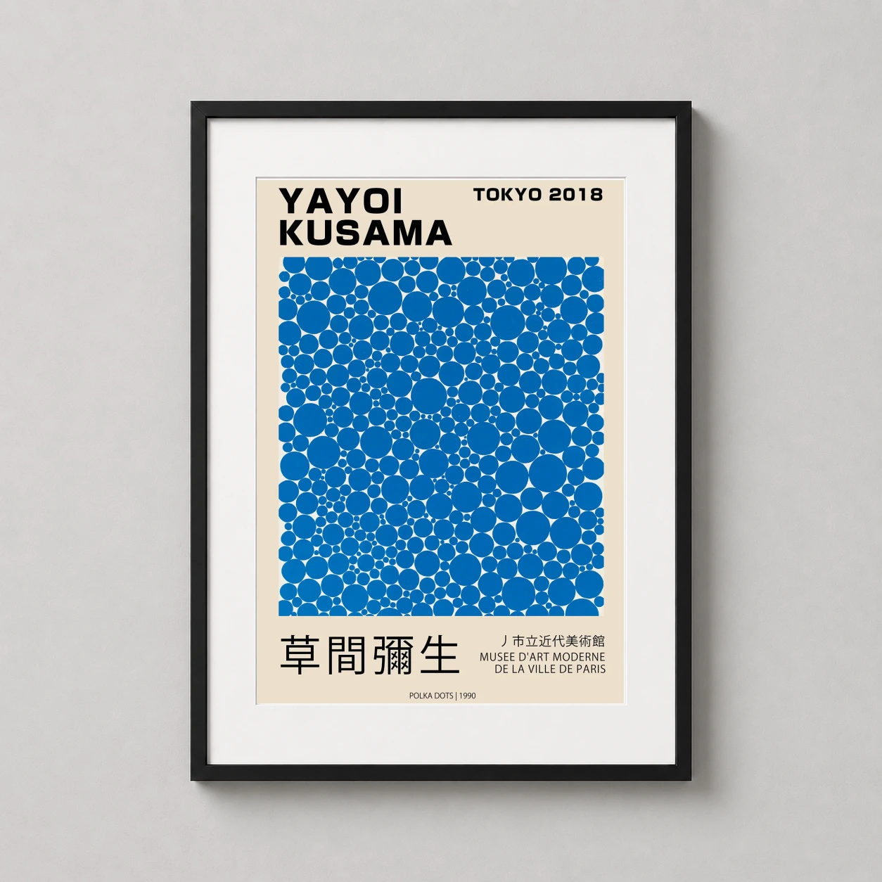 Room mockup of Yayoi Kusama Tokyo Exhibition Blue Polka Dots 1990 Art Print, displayed as framed wall art in a living room setting as a portrait print with blue and cream tones.