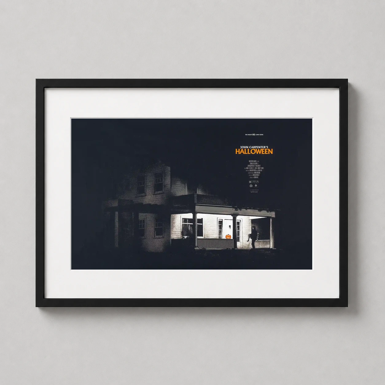 Room mockup of John Carpenter's Halloween Myers House Illustration Movie Poster, displayed as framed wall art in a home theater setting as a landscape print with orange tones.