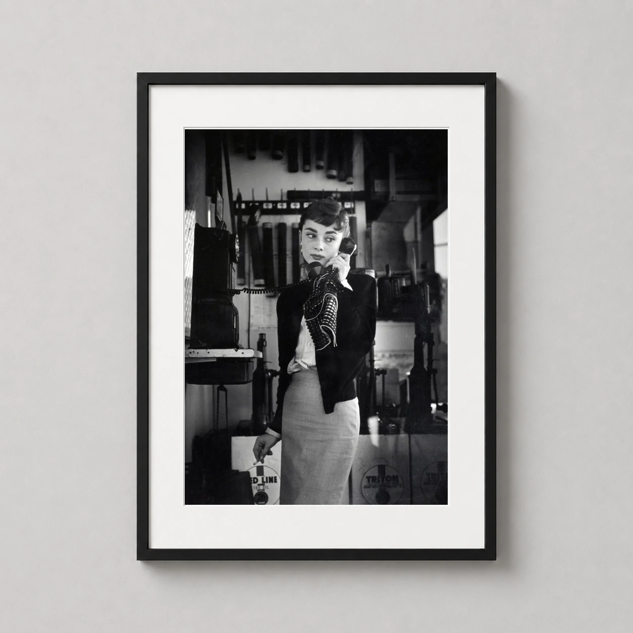 Audrey Hepburn Vintage Payphone — vintage monochrome photograph capturing Audrey Hepburn on a payphone