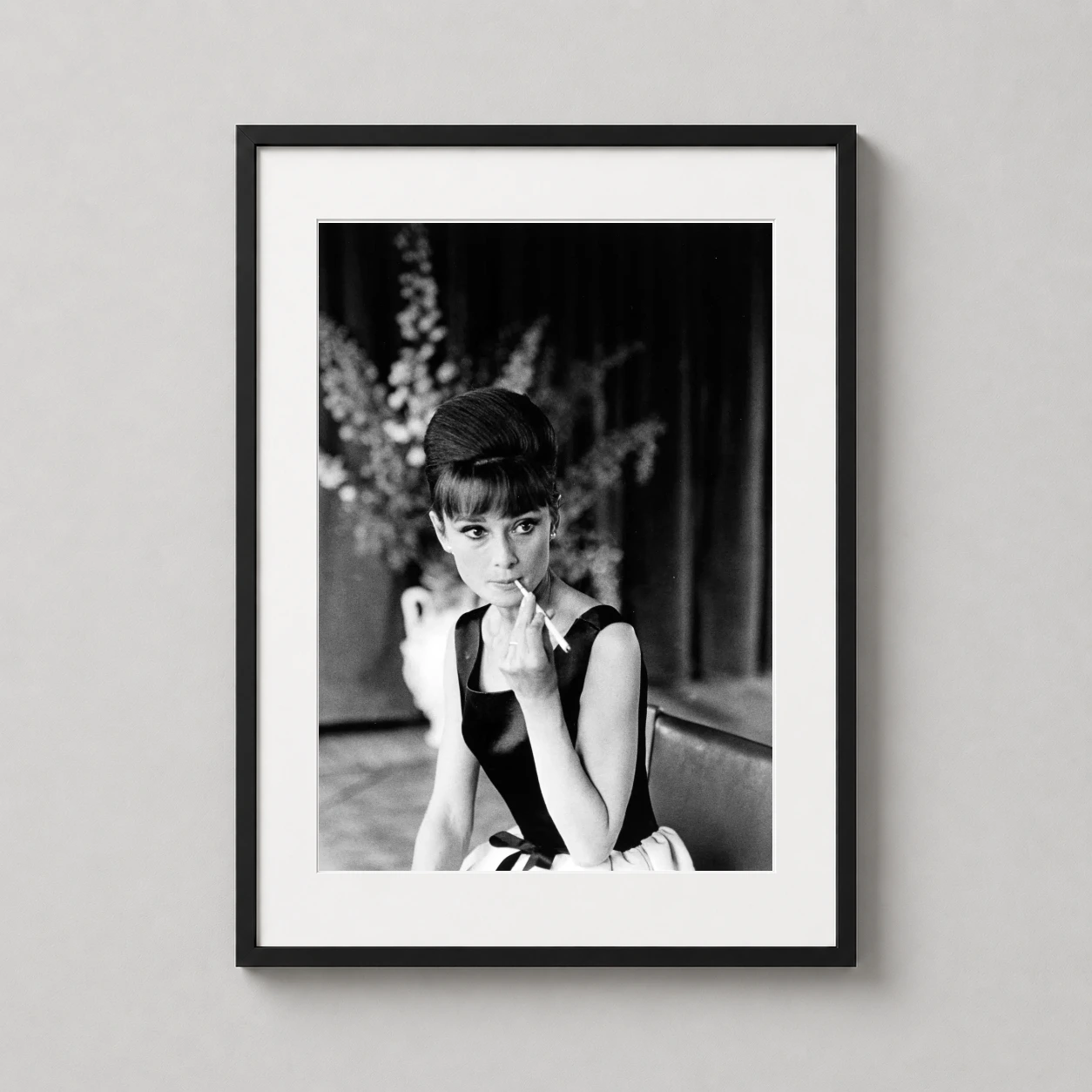 Audrey Hepburn Applying Lipstick — monochrome photography print capturing Audrey Hepburn applying lipstick