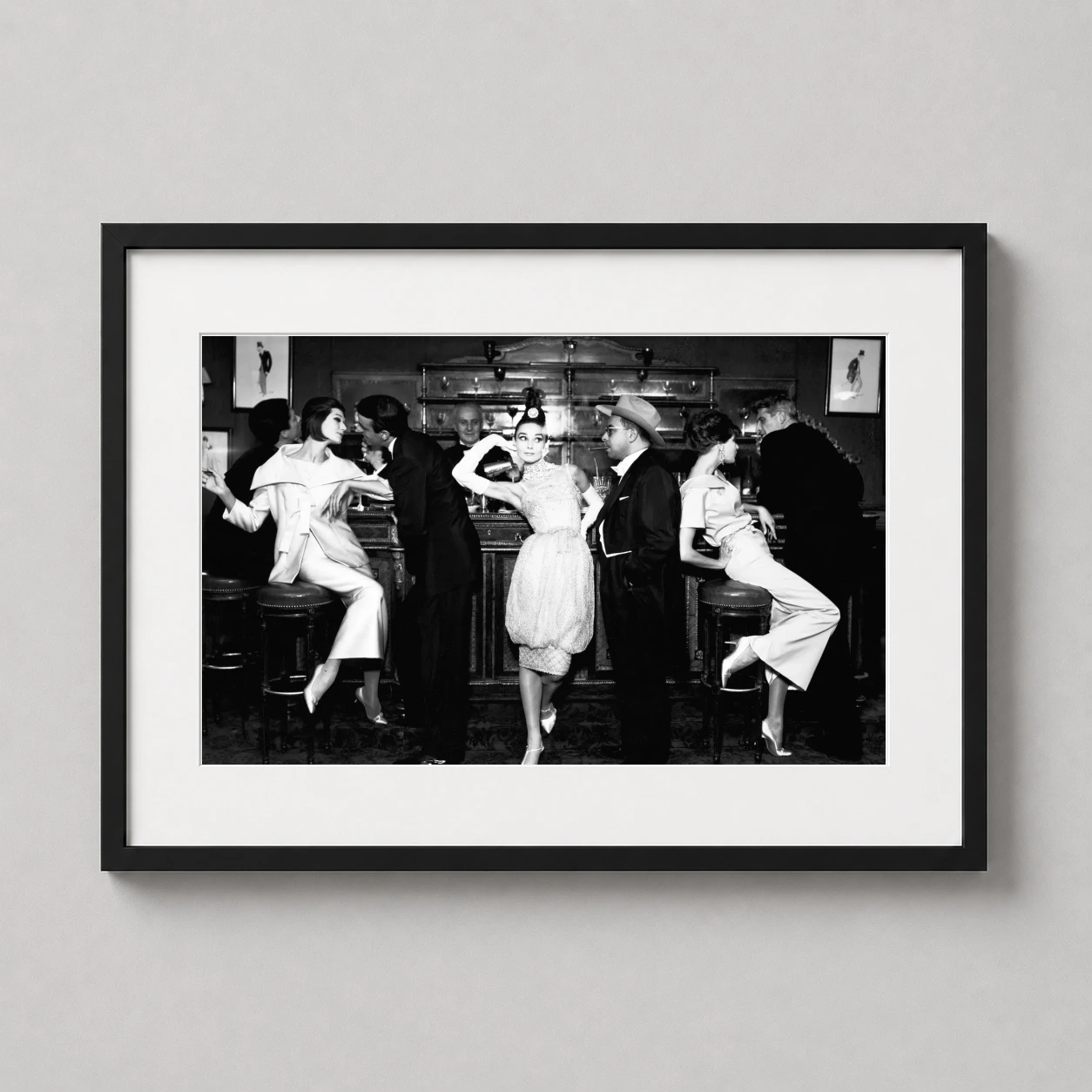 Audrey Hepburn Maxim's Paris — black and white photograph featuring Audrey Hepburn in a Dior evening