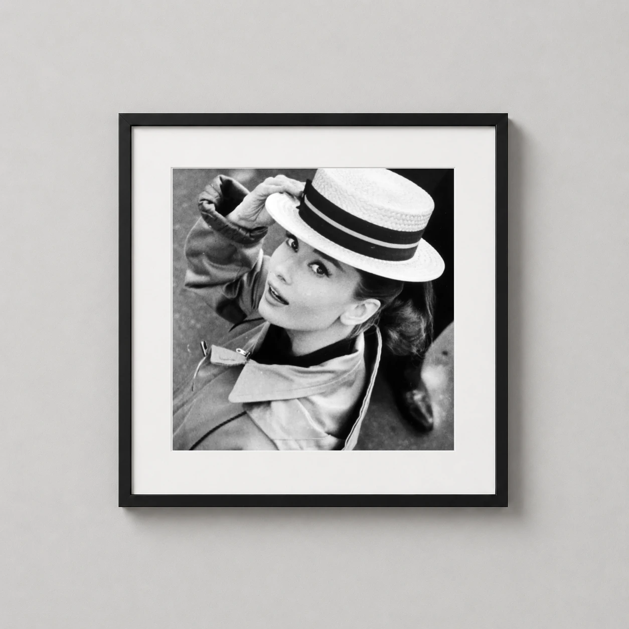 Audrey Hepburn Boater Hat — audrey Hepburn wearing a boater hat and trench coat, looking upward in