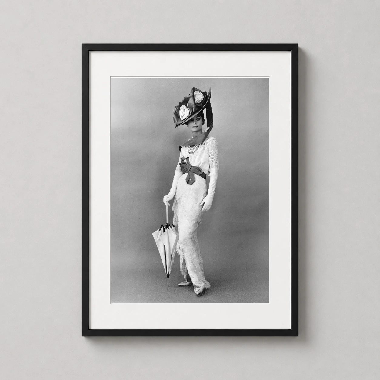 Room mockup of Audrey Hepburn 1963 My Fair Lady Cinema Portrait Photography Print, displayed as framed wall art in a home theater setting as a portrait print with black and white tones.