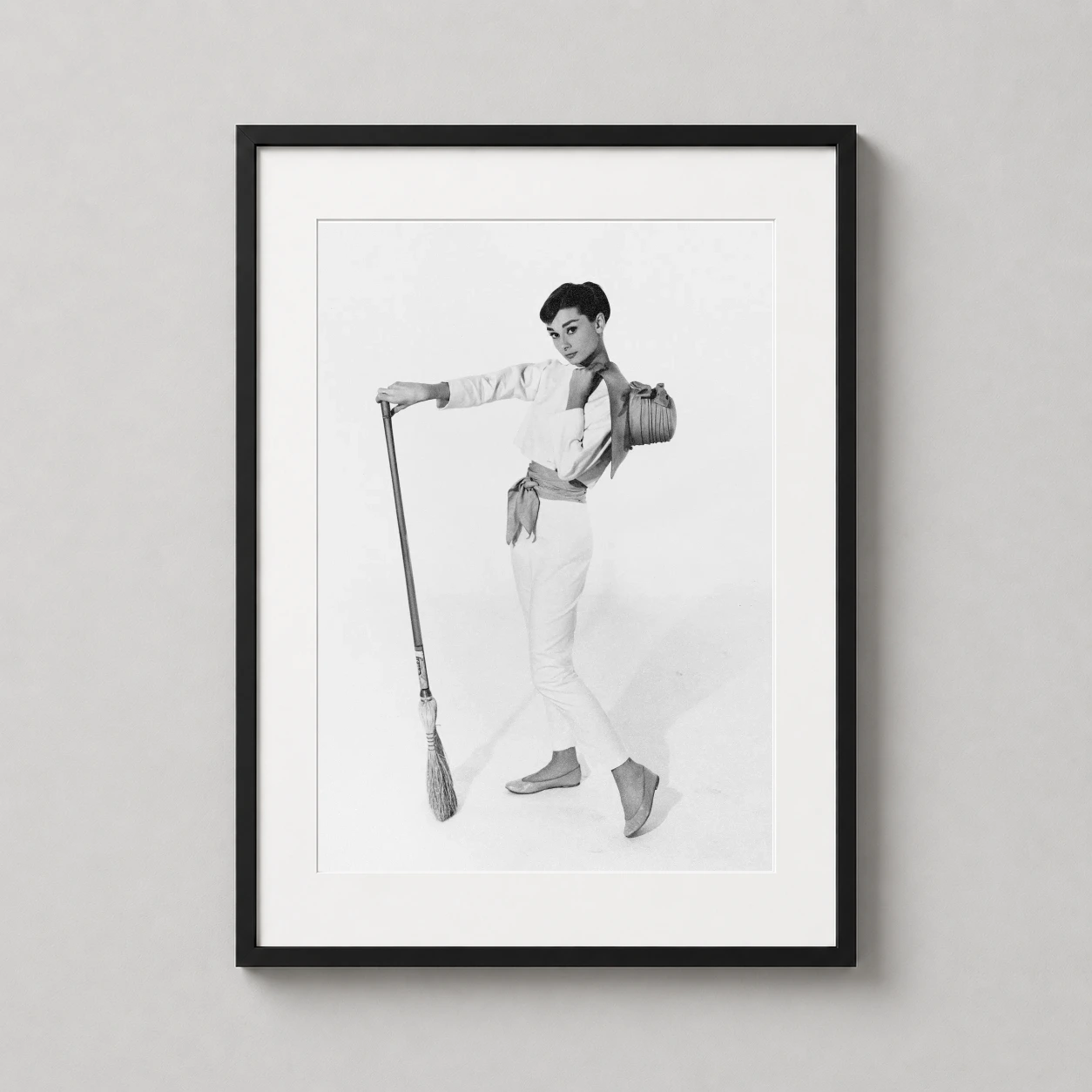 Audrey Hepburn Studio Portrait — black and white studio portrait of Audrey Hepburn posing playfully with