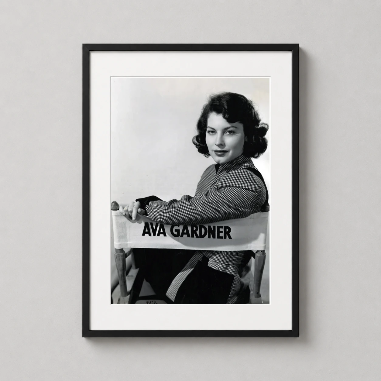 Ava Gardner — black and white portrait of actress Ava Gardner seated in a canvas
