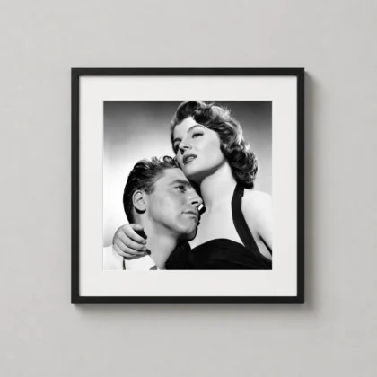 A framed vintage print of Ava Gardner and Burt Lancaster from The Killers hanging in a stylish modern bedroom.