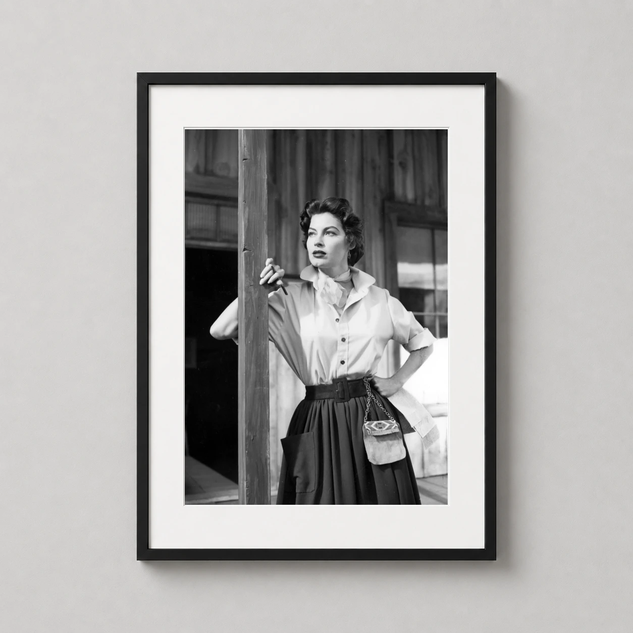 Room mockup of Ava Gardner Lone Star 1952 Black and White Movie Photography Print, displayed as framed wall art in a office setting as a portrait print with black and white tones.