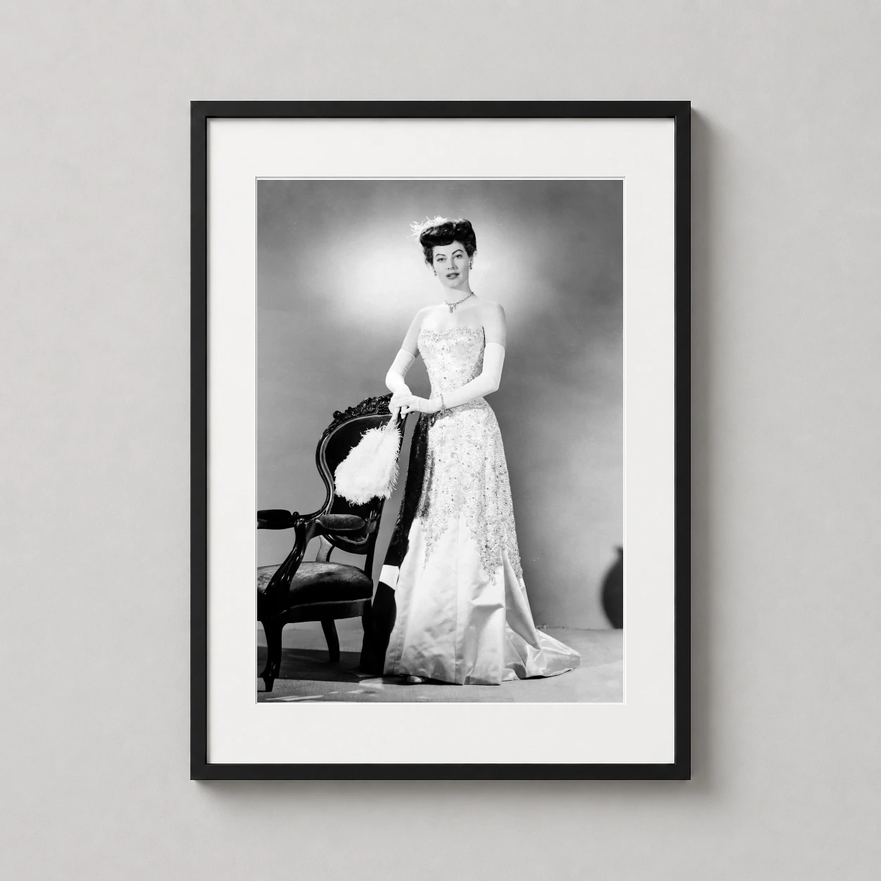 Room mockup of Ava Gardner in My Forbidden Past Studio Portrait Photography Print, displayed as framed wall art in a office setting as a portrait print with black and white and gold tones.