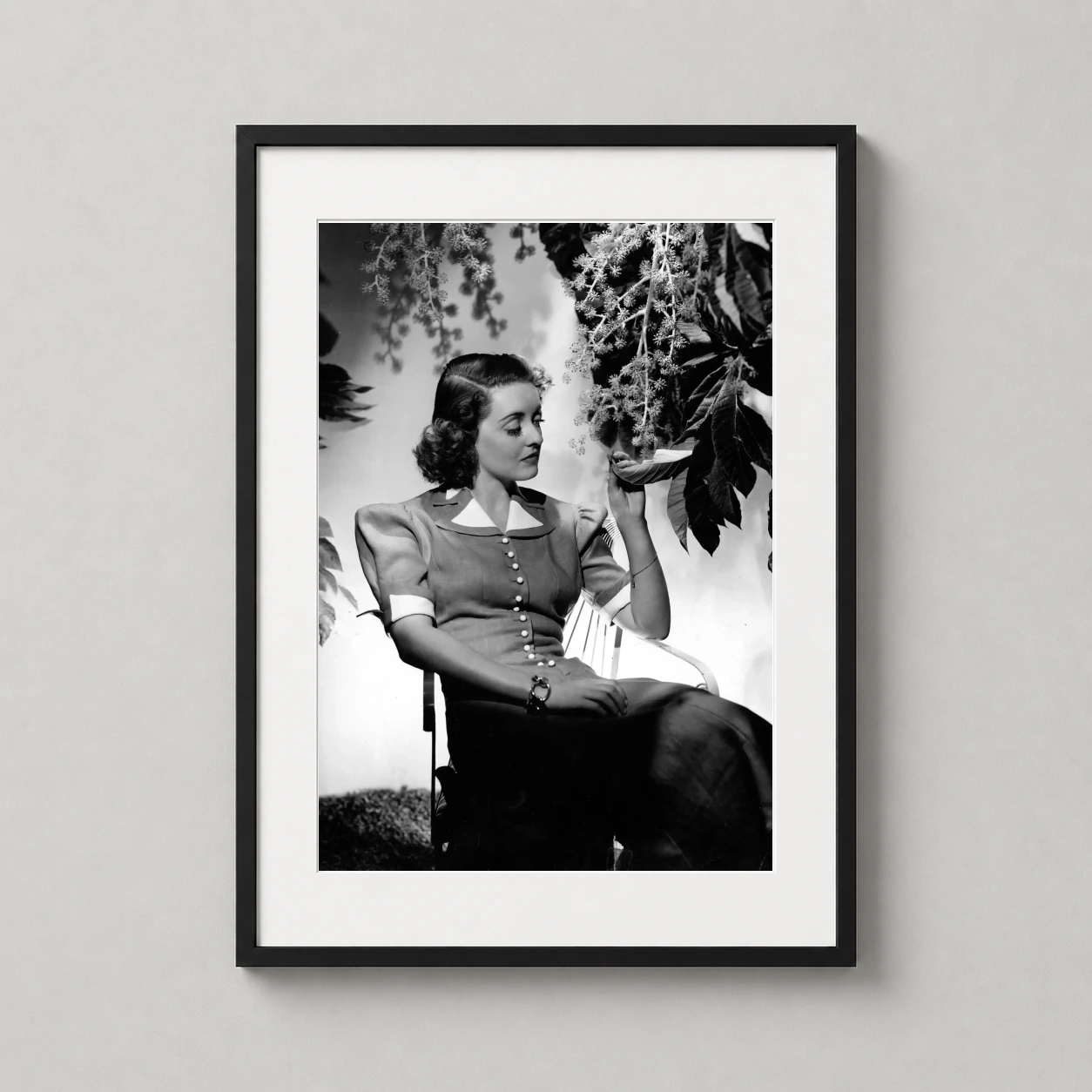 Bette Davis Garden Portrait — 1940s black and white portrait of Bette Davis seated in a garden