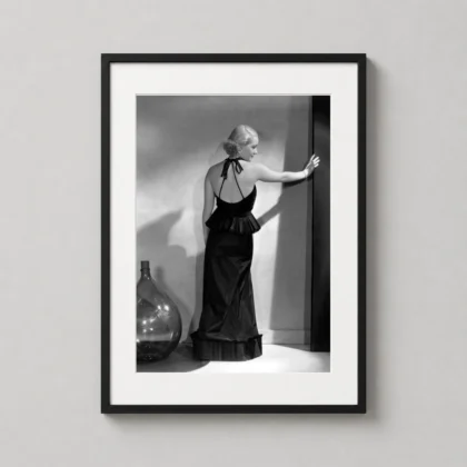 A framed Bette Davis studio art print hanging on a clean gallery wall above a modern console table.