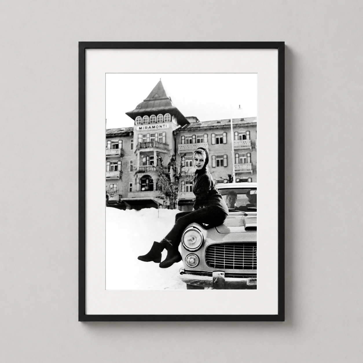 Brigitte Bardot Miramonti Hotel — this black and white photograph captures Brigitte Bardot perched on a