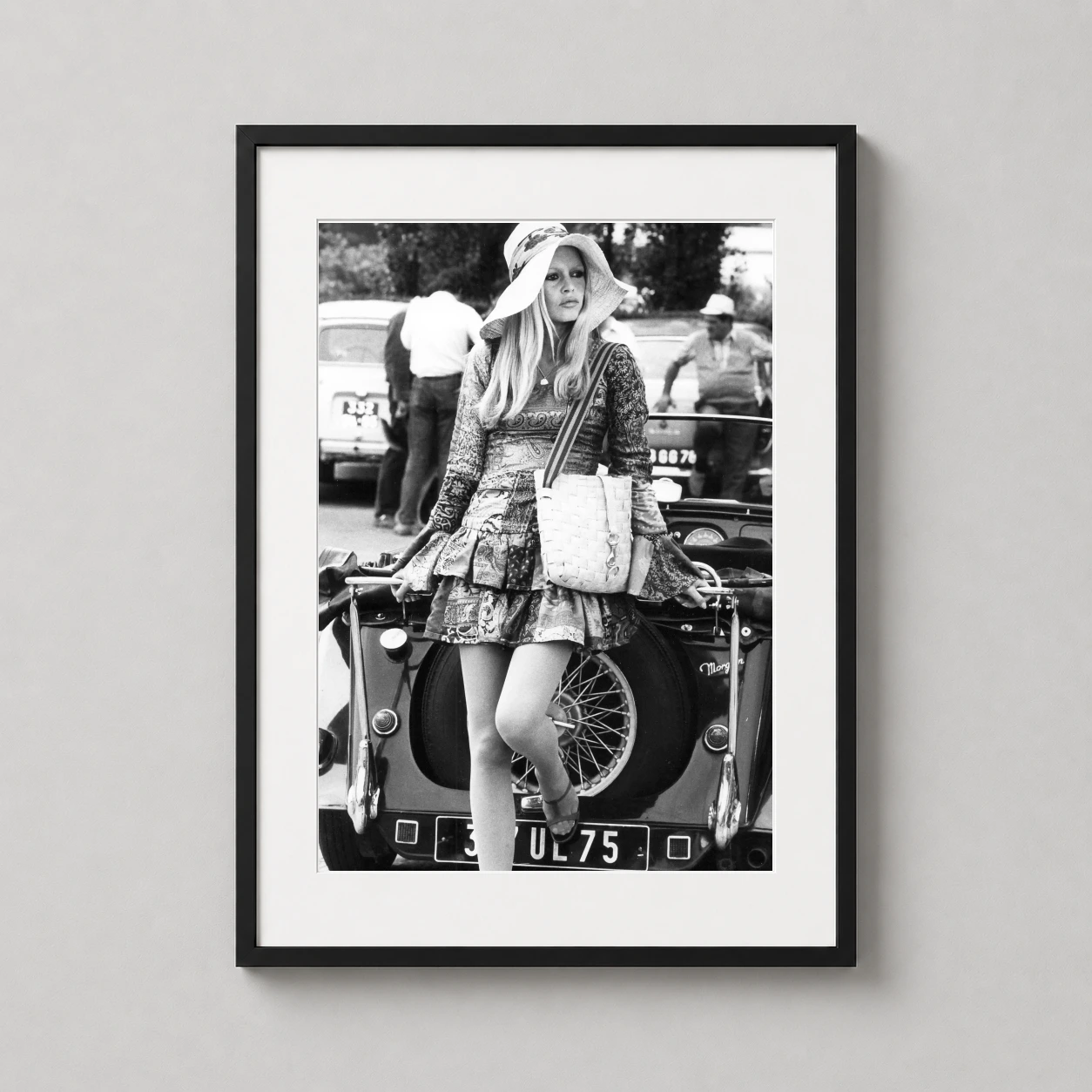 Brigitte Bardot Leaning Against — black and white photograph of Brigitte Bardot in a wide-brimmed hat and