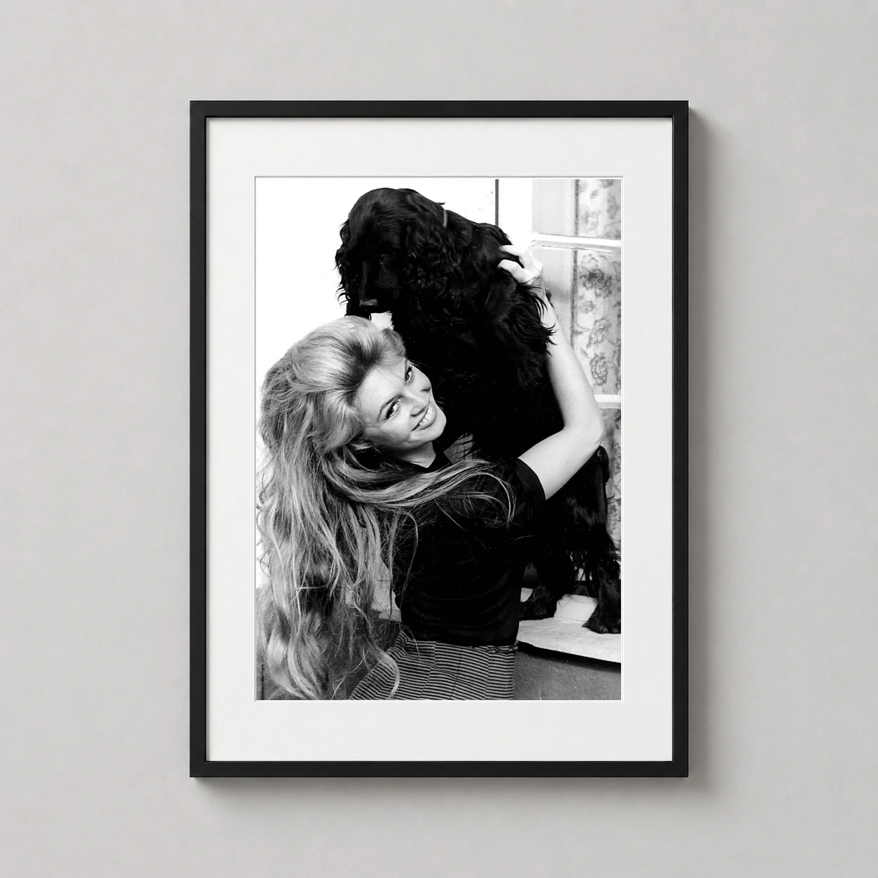 Brigitte Bardot Cocker Spaniel — black and white photograph of Brigitte Bardot smiling as she holds a