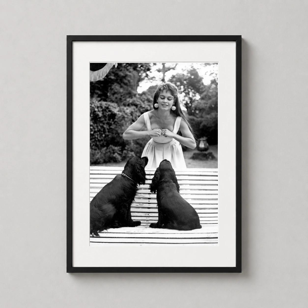 Brigitte Bardot Dogs 1954 — black and white photograph captures Brigitte Bardot in a sundress