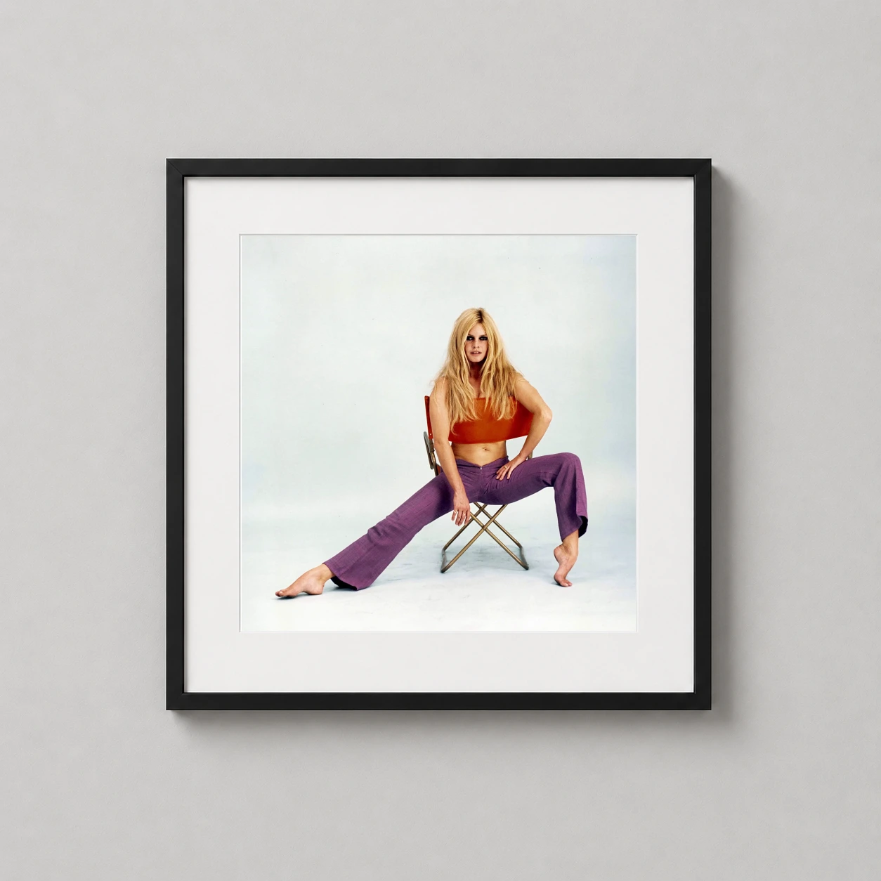 Brigitte Bardot 1967 Chair — vibrant 1967 studio photograph of Brigitte Bardot posed on a director's