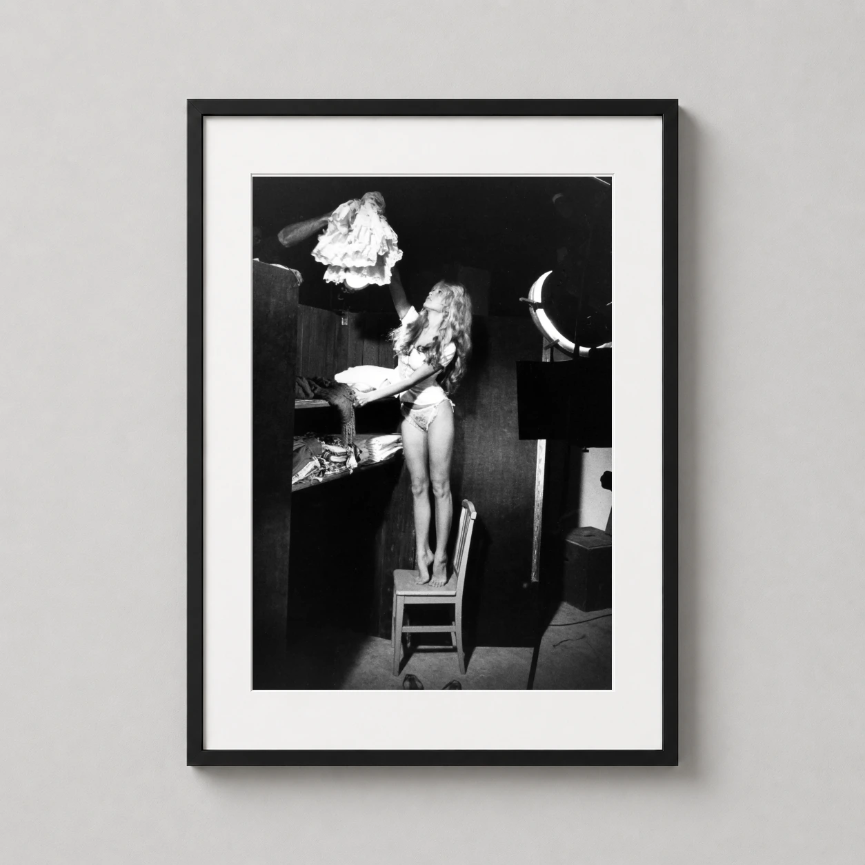 Brigitte Bardot Dressing Room — black and white candid photograph of Brigitte Bardot standing on a