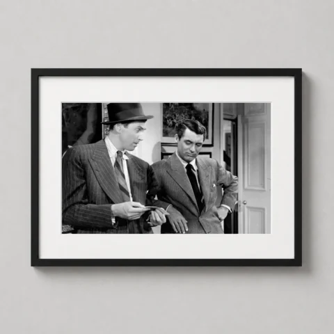 A framed black and white print of The Philadelphia Story featuring Cary Grant and James Stewart on a living room wall.