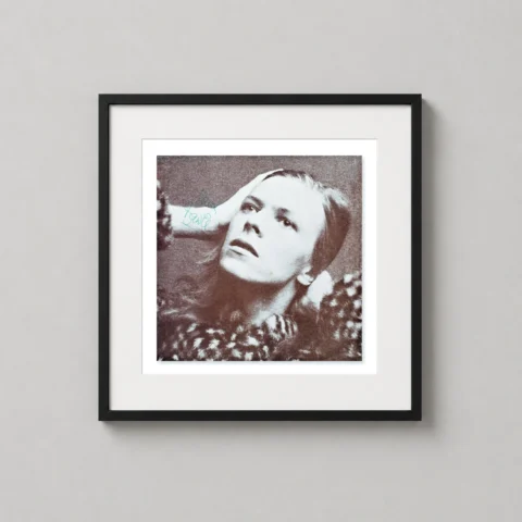Sepia-toned photographic portrait of David Bowie in a contemplative pose with a green signature, styled in a grainy vintage rock aesthetic.