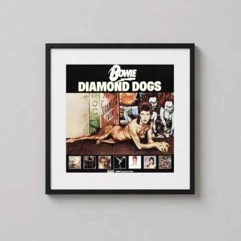 A framed David Bowie Diamond Dogs art print displayed on a dark accent wall in a modern living room setting.