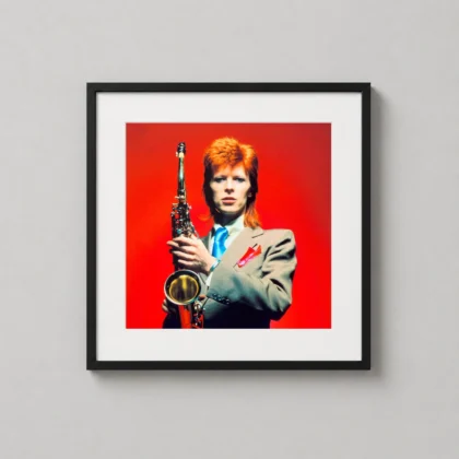 David Bowie saxophone portrait print showing a colour portrait of Bowie holding a saxophone against a red backdrop as David