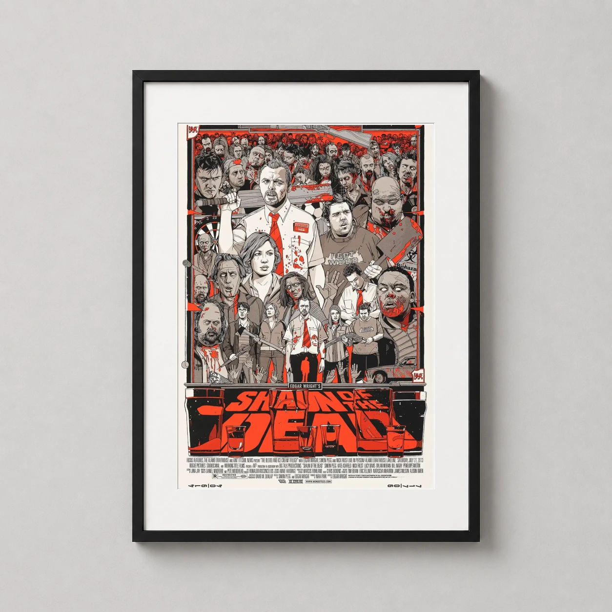 Room mockup of Shaun of the Dead Tyler Stout Mondo Design Movie Poster, displayed as framed wall art in a home theater setting as a portrait print with red, black, and white tones.