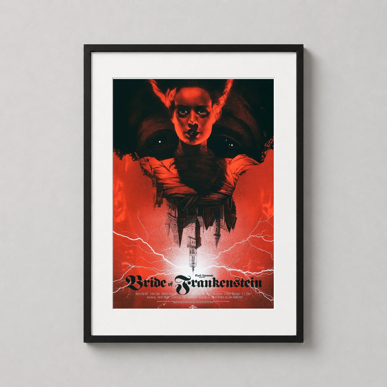 Room mockup of Bride of Frankenstein Greg Ruth Mondo Style Horror Movie Poster, displayed as framed wall art in a home theater setting as a portrait print with gold, red, and black tones.