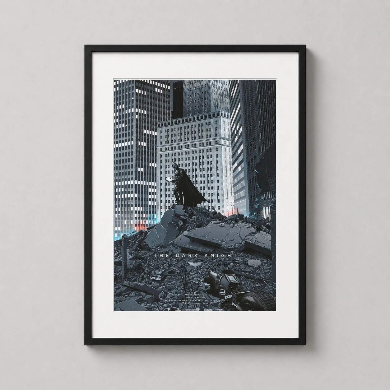 Room mockup of The Dark Knight Laurent Durieux Gotham City Movie Poster, displayed as framed wall art in a home theater setting as a portrait print with blue, orange, and grey tones.