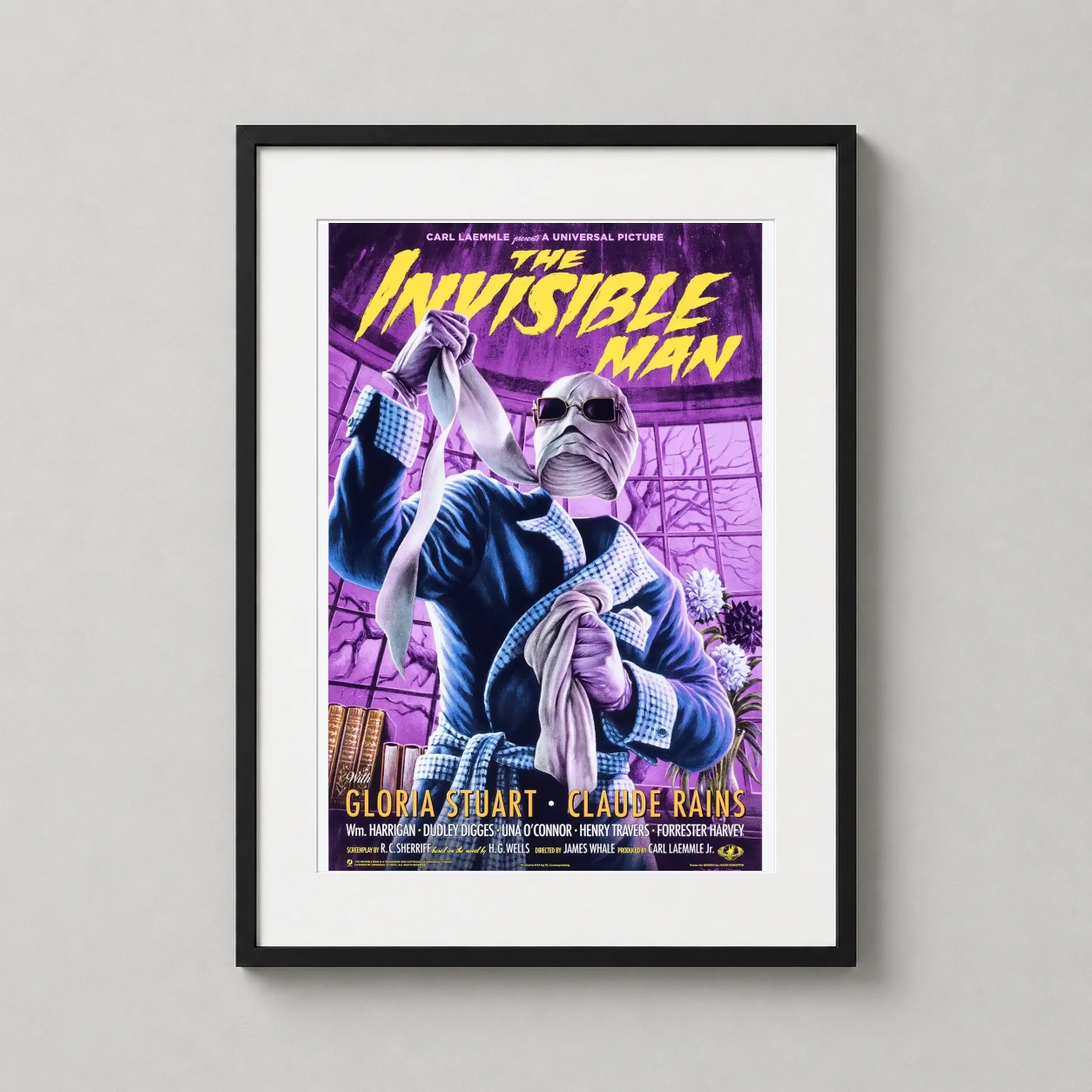 Room mockup of The Invisible Man Mondo Monster Movie Poster by Jason Edmiston, displayed as framed wall art in a home theater setting as a portrait print with blue, yellow, and purple tones.
