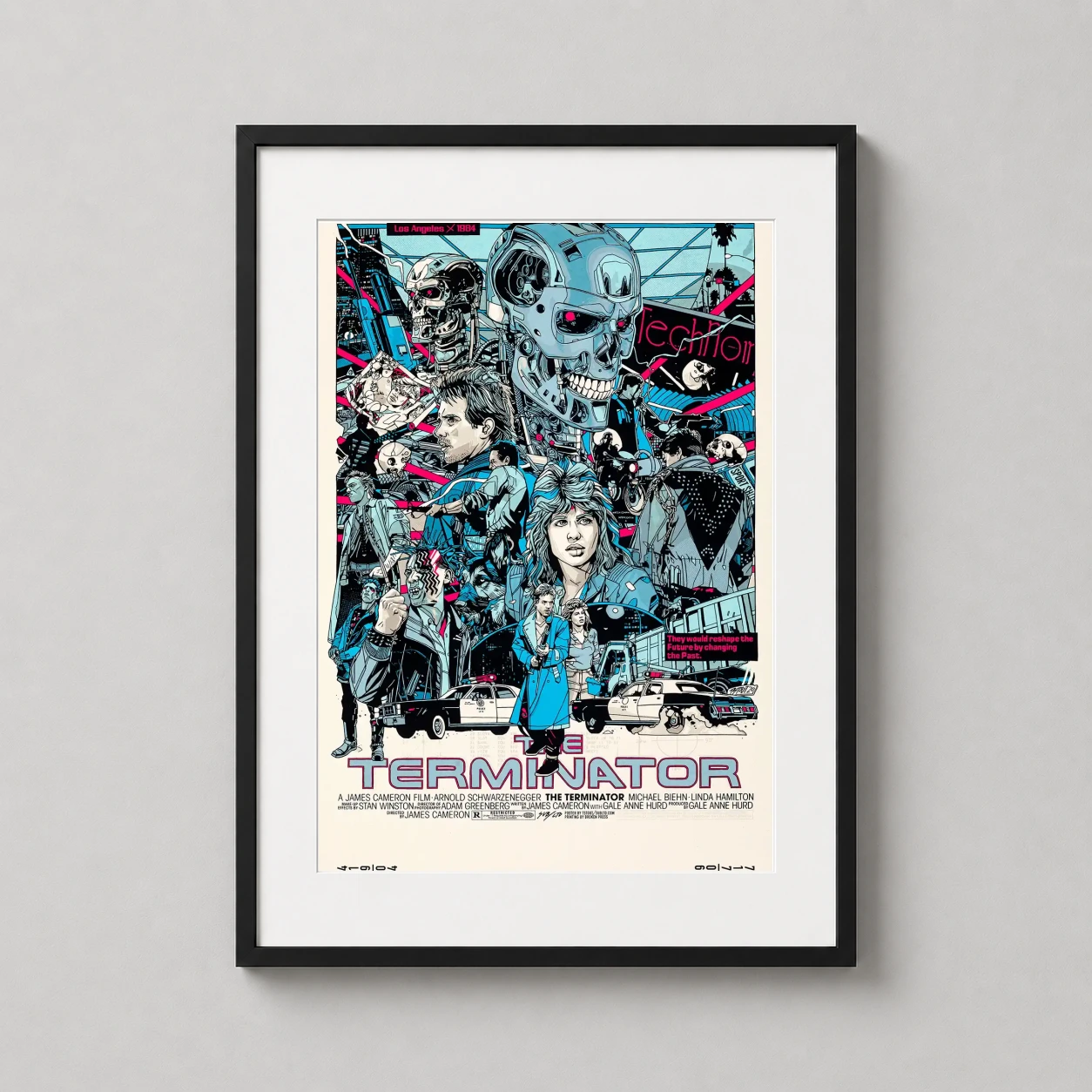 Room mockup of The Terminator 1984 Tyler Stout Los Angeles Movie Poster, displayed as framed wall art in a home theater setting as a portrait print with teal and pink tones.