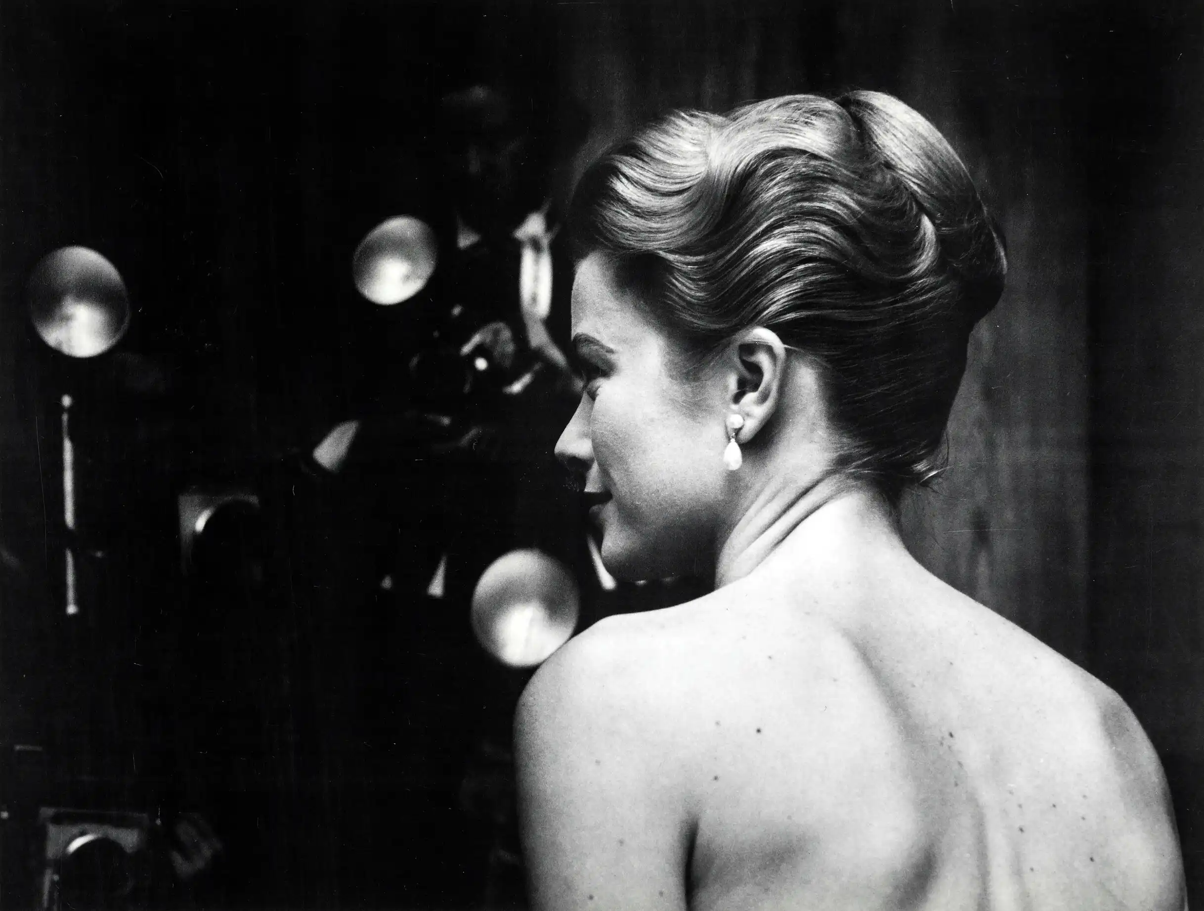 Leigh Wiener Kelly poster showing a December 1955 back-view portrait with sculpted hair.