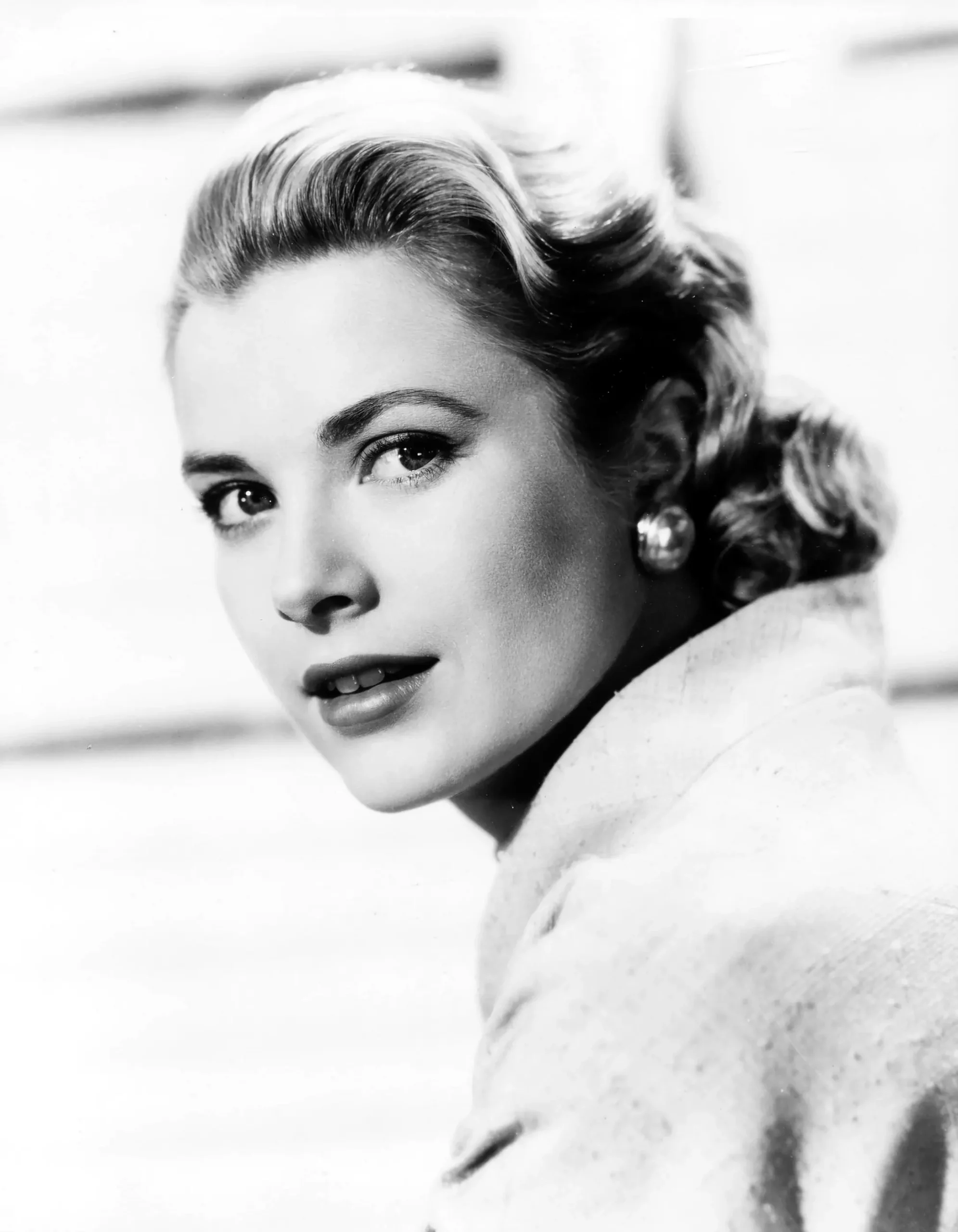 Bud Fraker Kelly poster showing a Paramount 1950s side-turned black-and-white portrait.