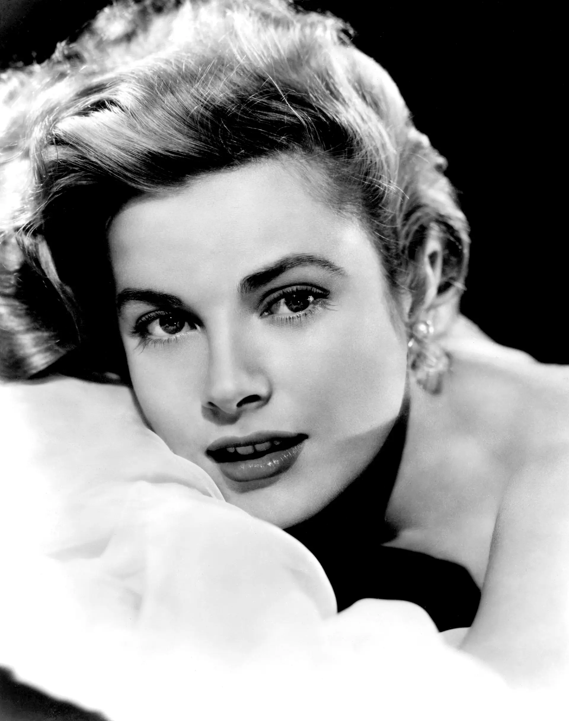 Grace Kelly Monaco poster showing a 1953 close black-and-white portrait resting on a pillow.