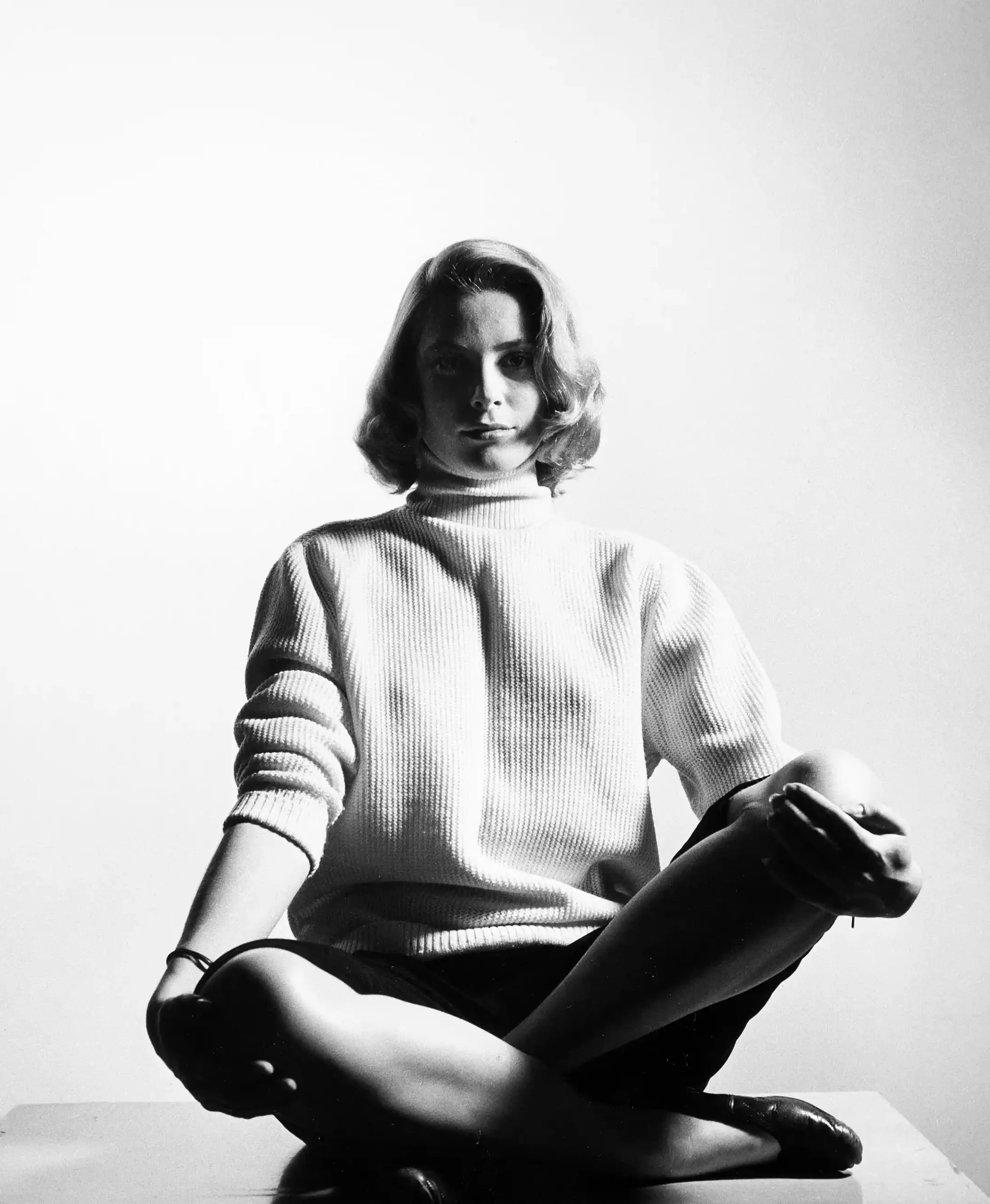 Grace Kelly seated poster showing a 1953 cross-legged studio pose in a knit top.