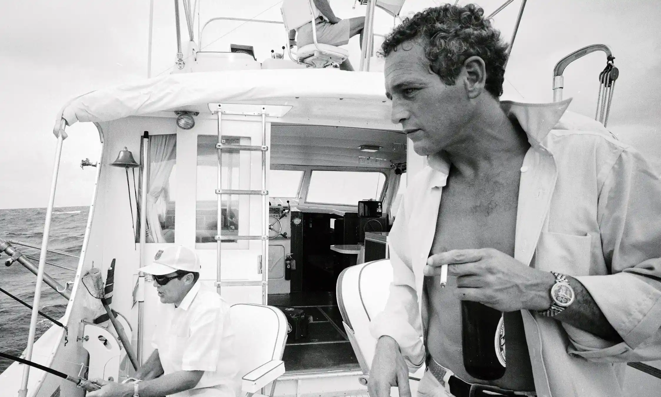 Paul Newman Fishing Boat — paul Newman appears on a fishing boat deck in a black-and-white candid