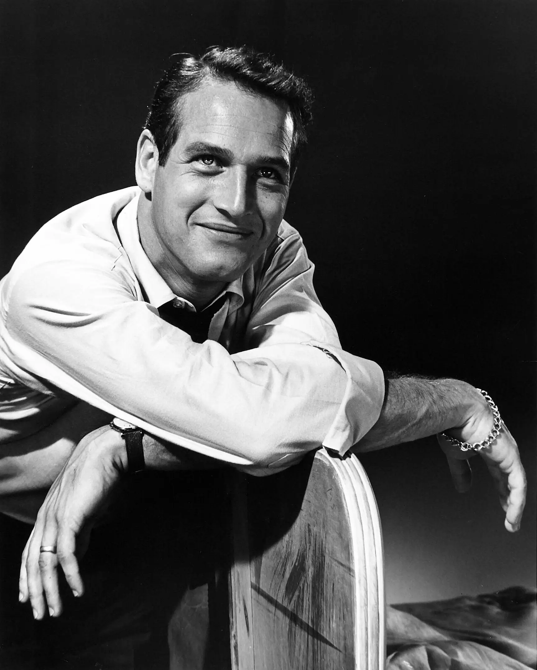 Paul Newman Publicity Still — relaxed publicity-style portrait shows Paul Newman seated with rolled