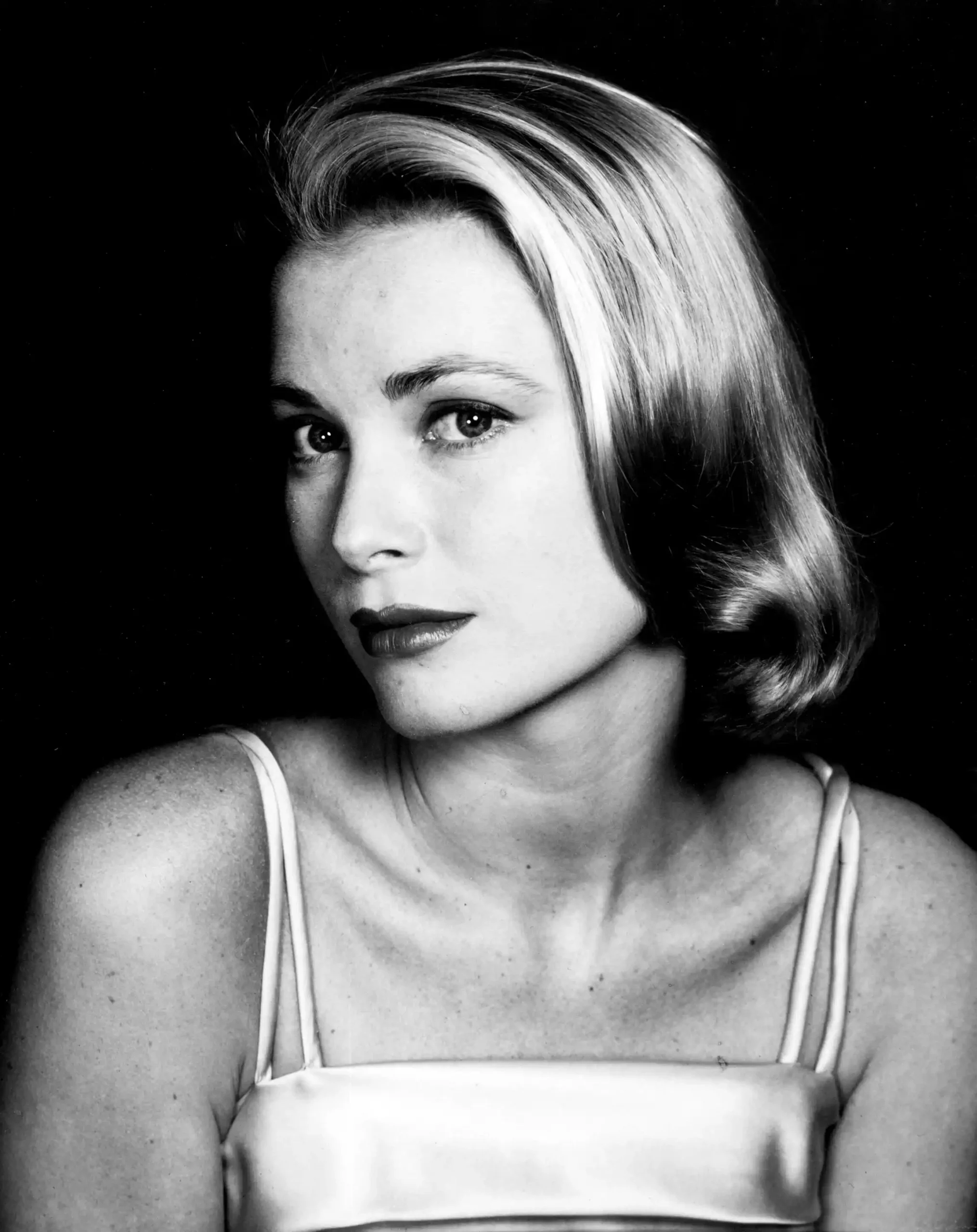Halsman Grace Kelly poster showing a direct black-and-white studio portrait in a pale strap dress.