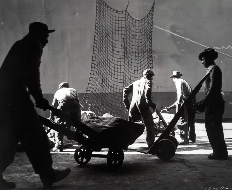 A. Aubrey Bodine poster showing longshoremen at work in a 1955 harbor photograph.