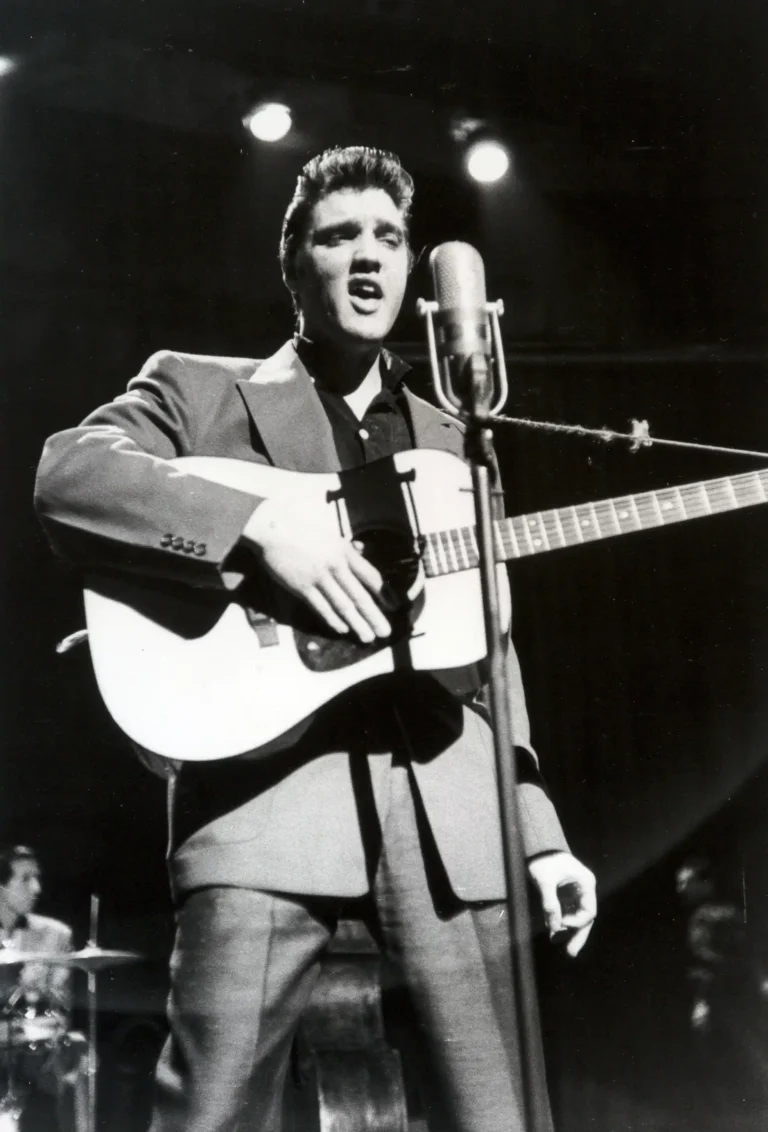 Alfred Wertheimer poster showing Elvis Presley performing on stage in 1956.