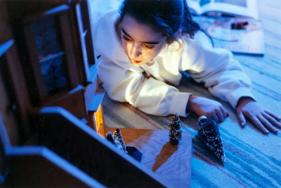Gregory Crewdson poster showing a girl with a dollhouse in an early staged photographic scene.