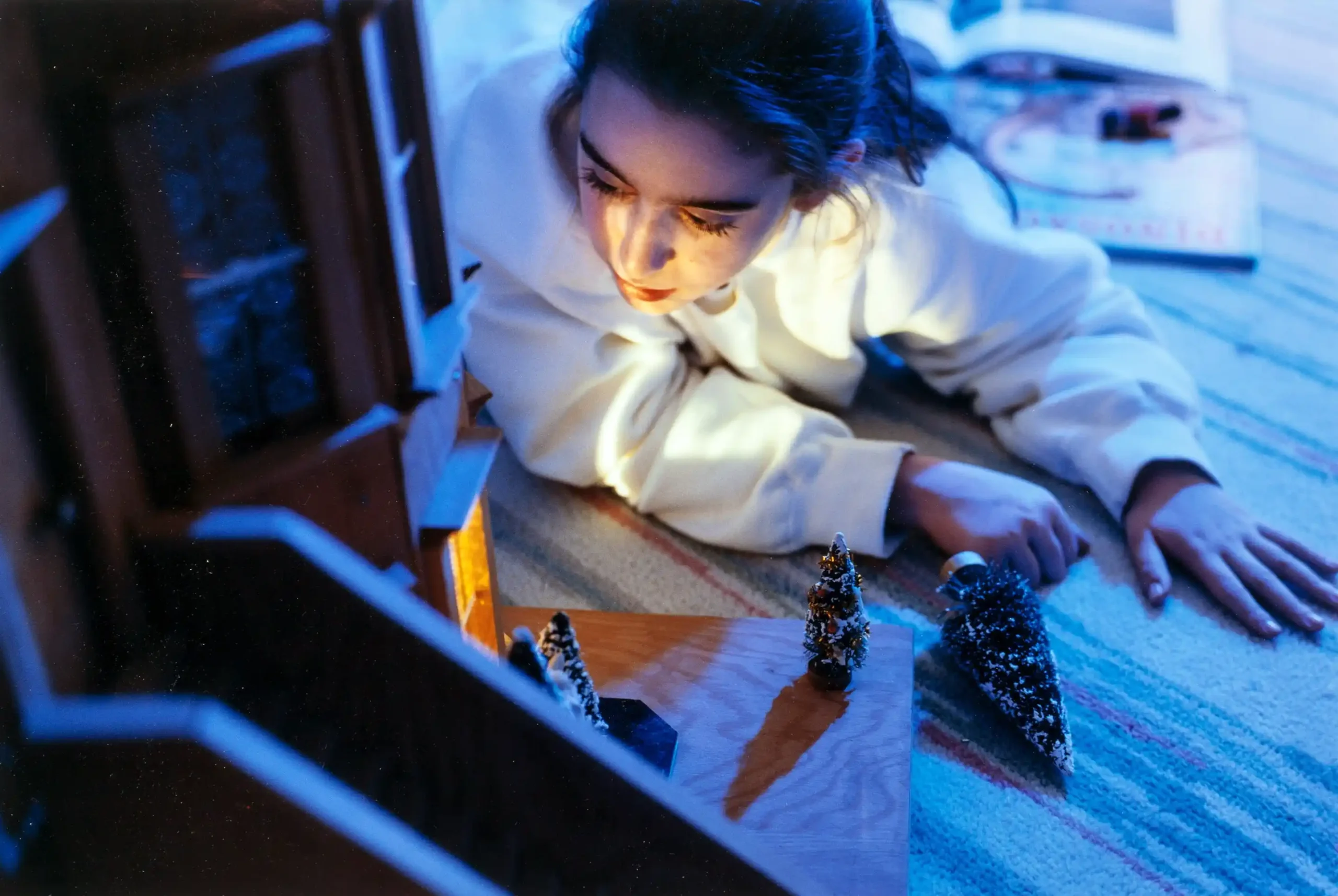 Gregory Crewdson poster showing a girl with a dollhouse in an early staged photographic scene.