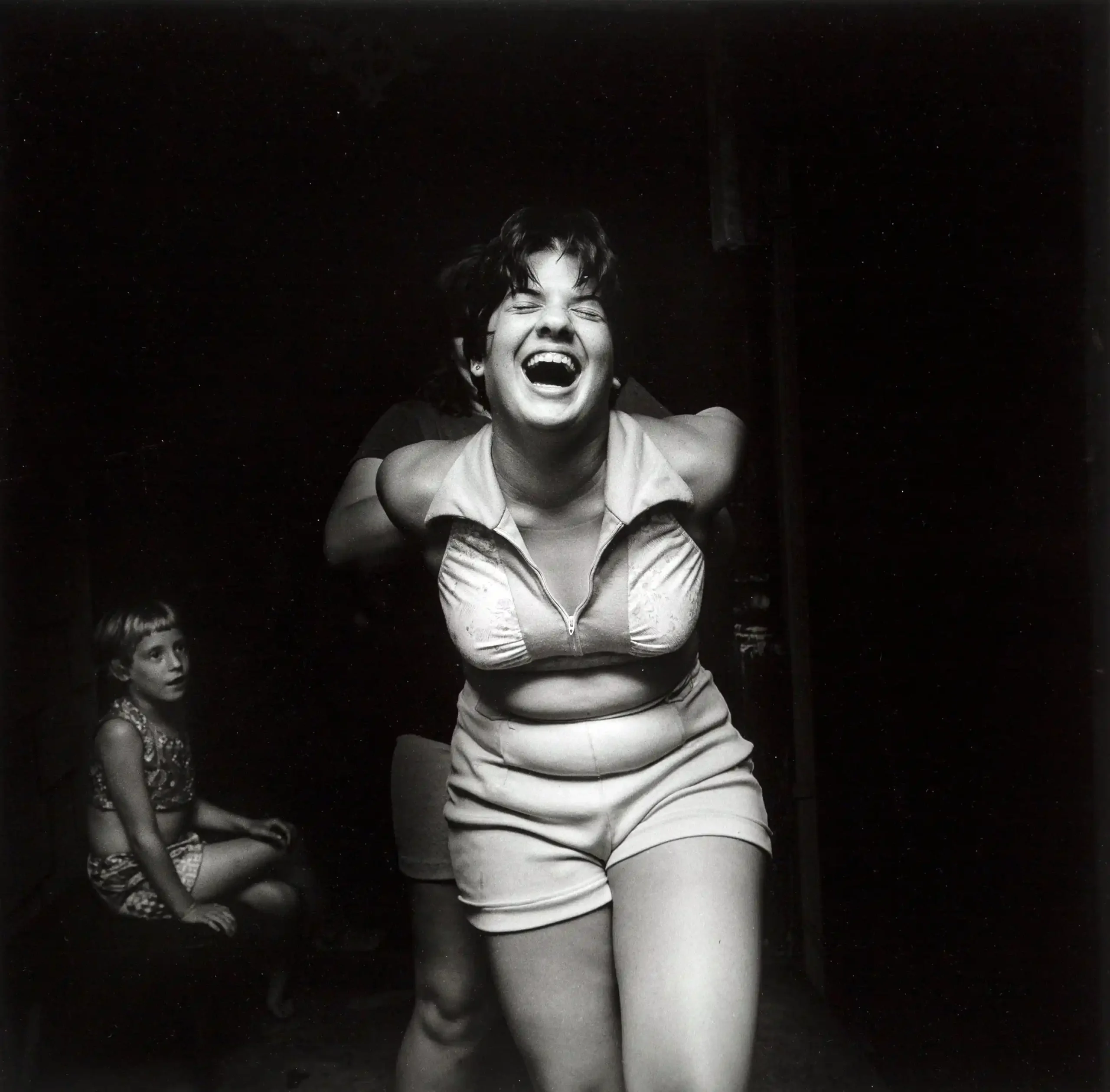 Larry Fink poster showing a graduation party scene with late-1970s social detail.