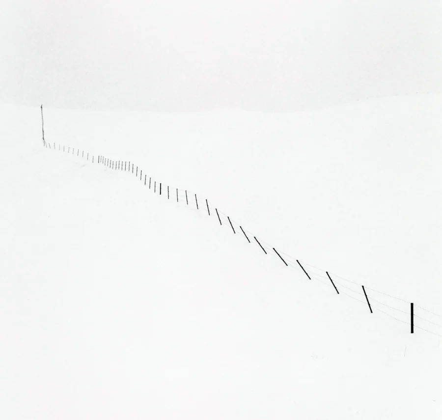 Michael Kenna poster showing a sparse Hokkaido hillside fence in winter-like quiet.