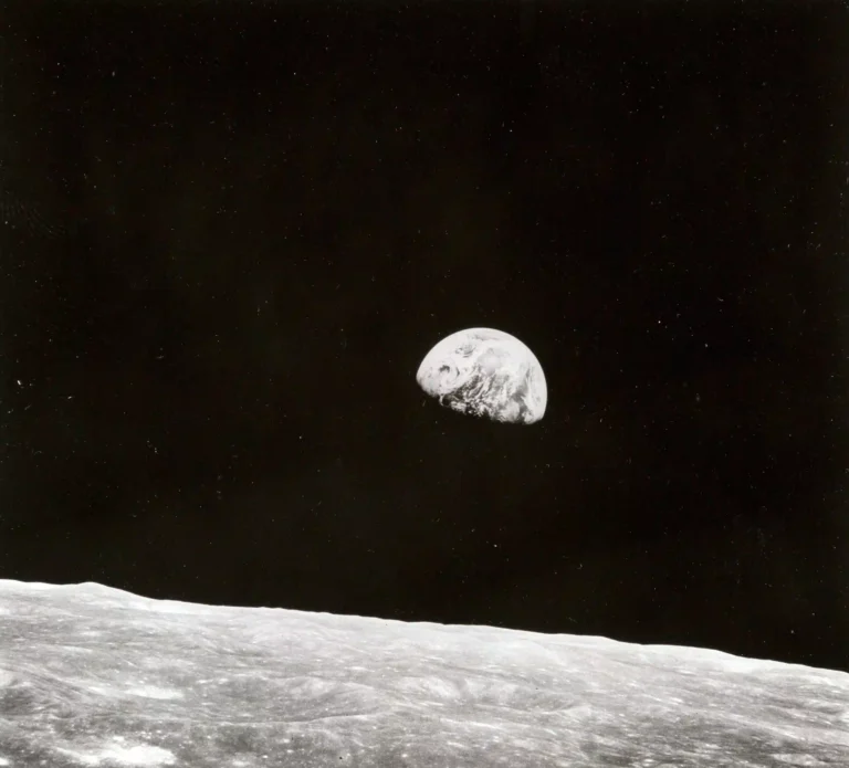 Clean artwork view of NASA Earthrise Apollo 8 1968 Photography Print. Earthrise Apollo Photography Print presents Earthrise Apollo 8 1968 by NASA, a fine-art image from 1968 shaped by Earth suspended over the lunar horizon.