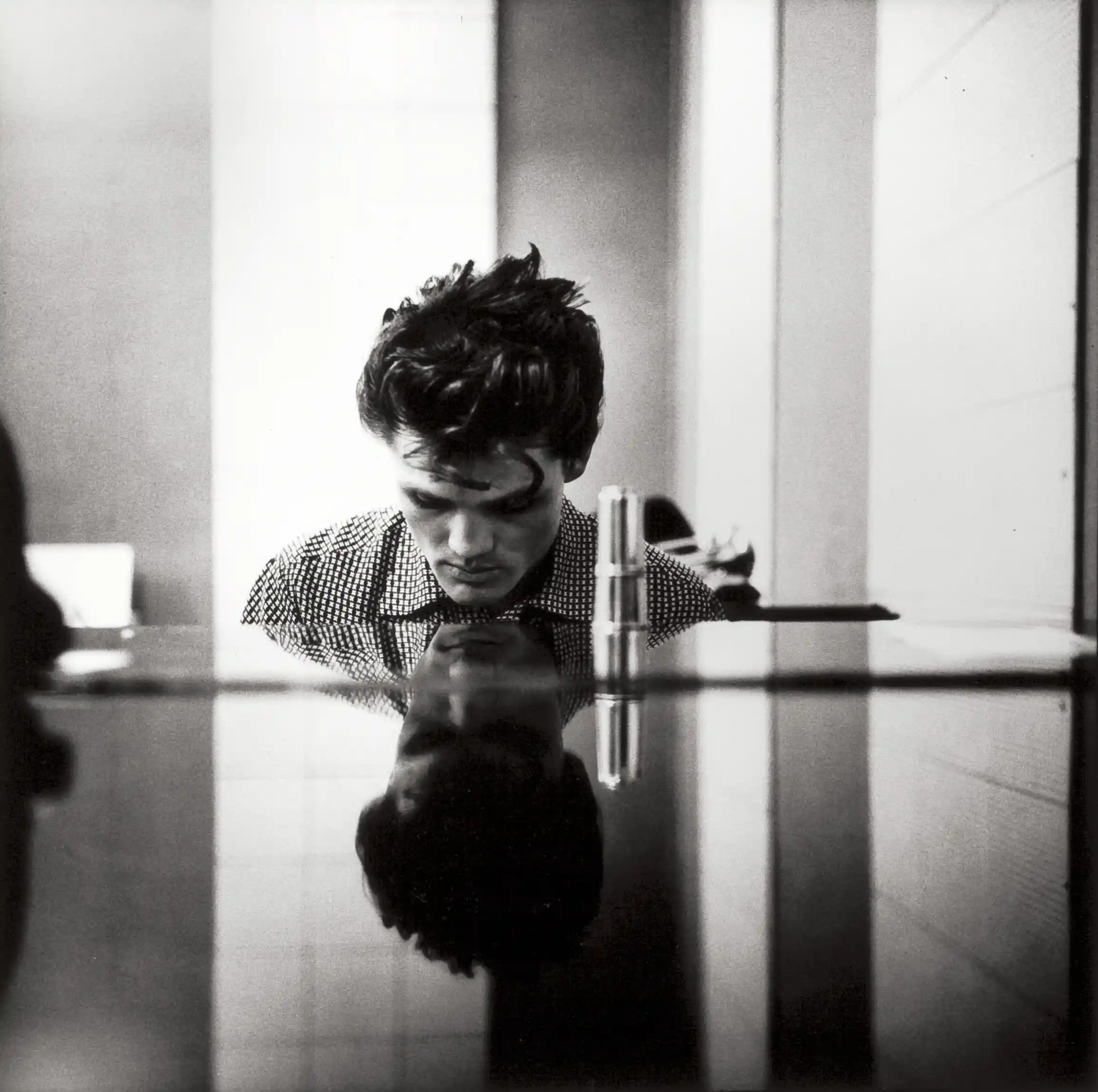 William Claxton poster showing Chet Baker seated at a piano in a 1954 Hollywood music portrait.