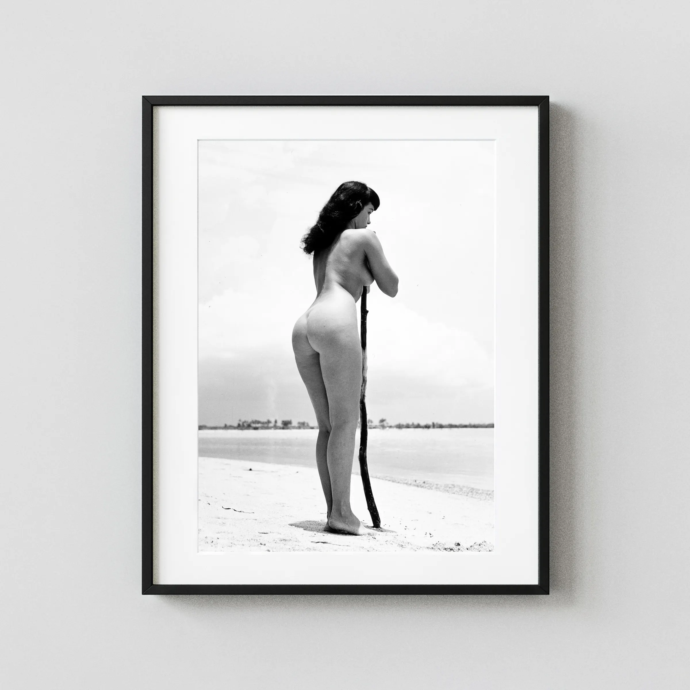 Bettie Page On The Beach 1954 Alternate View Nude displayed as a framed wall mockup