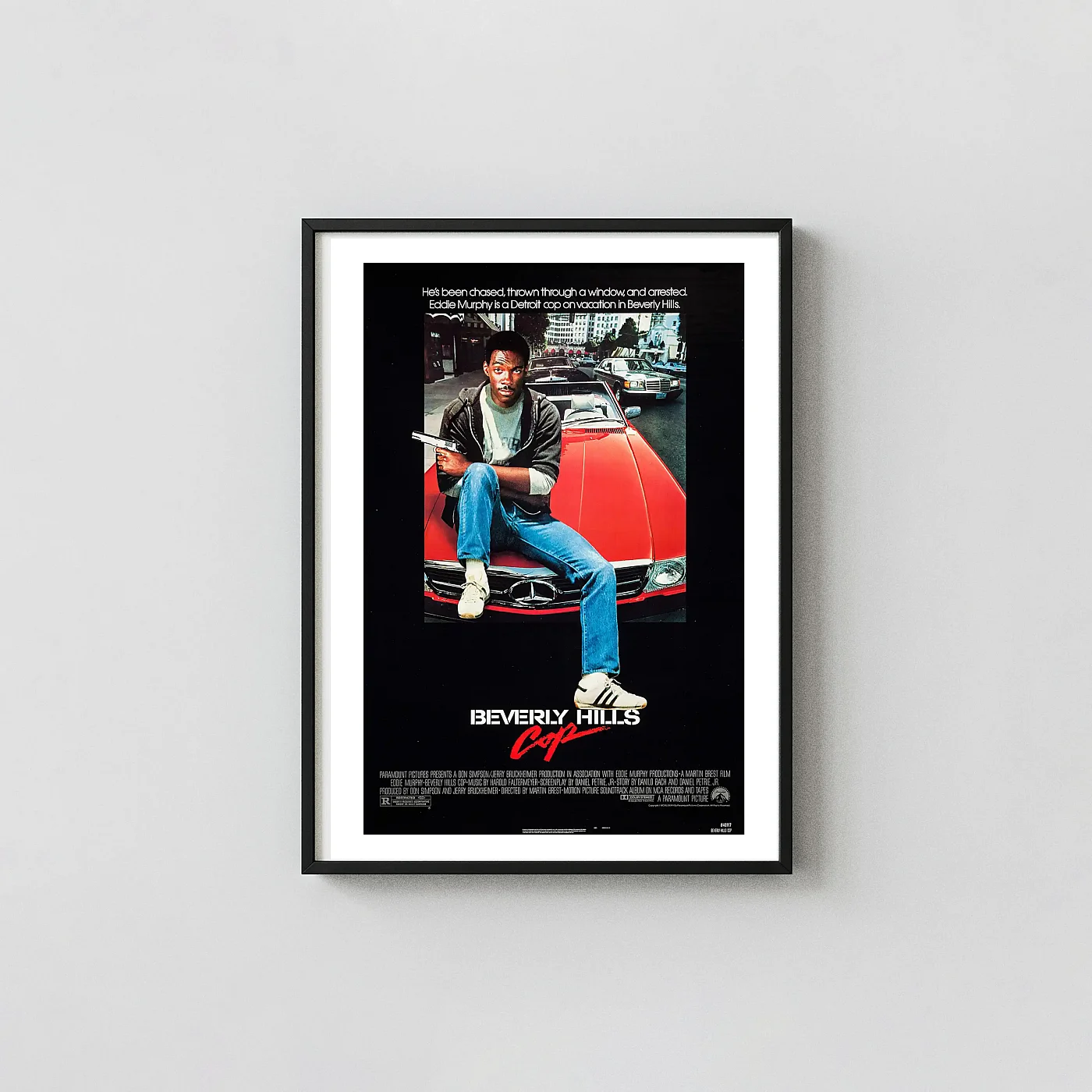 Beverly Hills Cop | Movie Poster | Axel Foley on Red Car Vintage Action & Adventure Movie Posters xe2x80x93 Portrait Frame Wall Art Mockup | MerchFuse